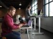 Man sitting at a desk. Photo by TheStandingDesk on Unsplash